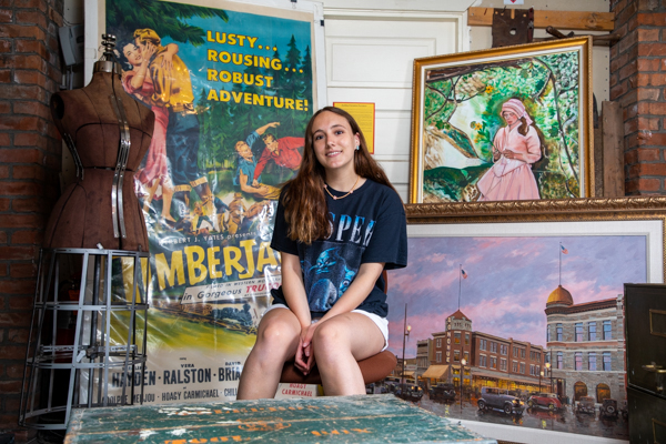 Beth Schofield sits amongst historical pieces at the Historical Museum at Fort Missoula