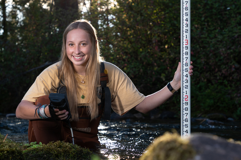 A geoscience student surveys Rattlesnake Creek